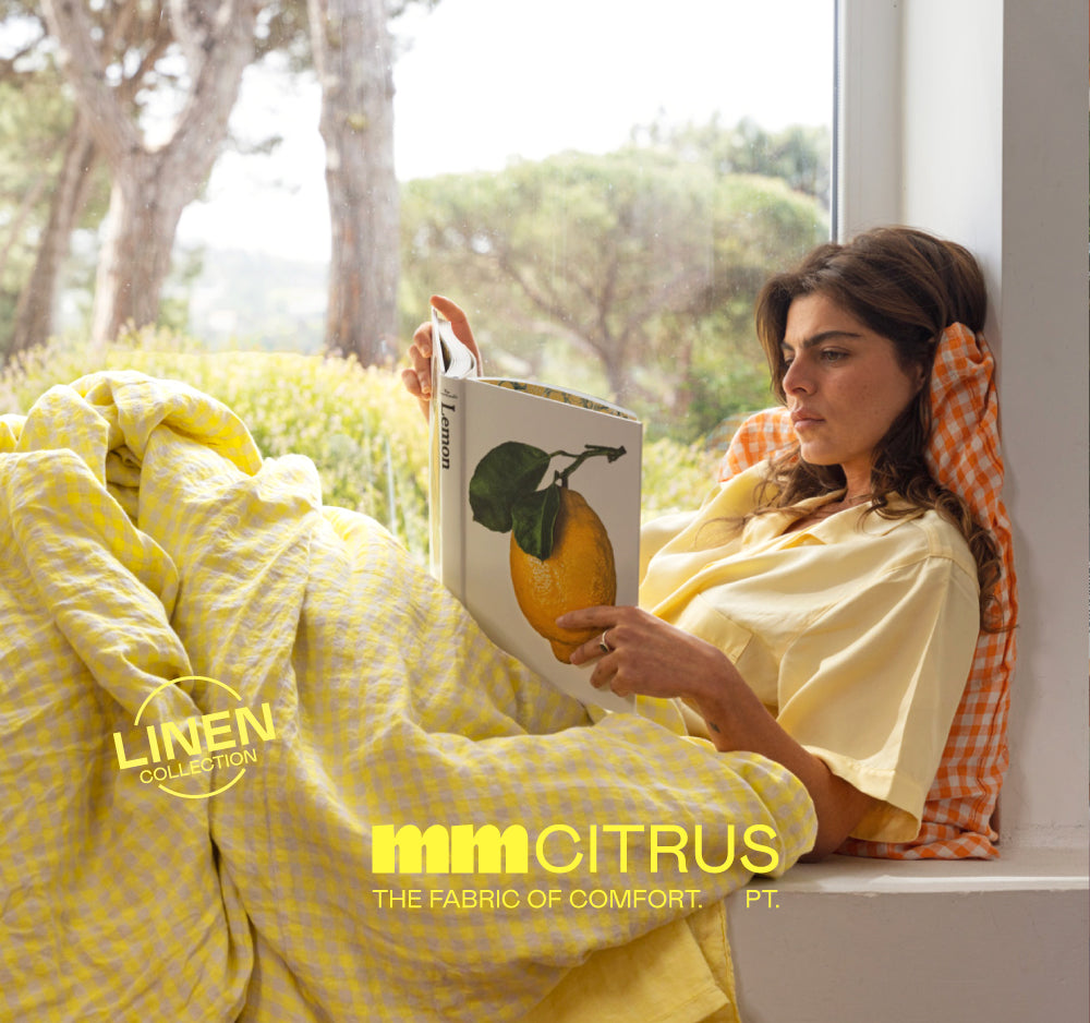 Reading by the window under a lemon linen duvet.